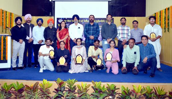 participants with their winning trophies